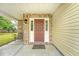 Close-up of the brick-accented front porch featuring a dark brown front door with sidelights at 1042 Cobblestone Blvd, Summerville, SC 29486