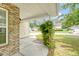 Cozy front porch with brick accents and partial view of the front yard and surrounding neighborhood at 1042 Cobblestone Blvd, Summerville, SC 29486