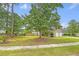 Expansive front yard with large trees shading the home's facade and offering curb appeal at 1042 Cobblestone Blvd, Summerville, SC 29486