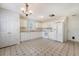 Well-lit kitchen boasts white appliances, cabinetry, ample counter space, and flooring with a distinctive patterned design at 1042 Cobblestone Blvd, Summerville, SC 29486