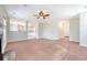 Open-concept living area with plush carpet, a fireplace, and seamless flow into the kitchen at 1042 Cobblestone Blvd, Summerville, SC 29486