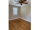 Small, sunlit bedroom featuring hardwood floors, neutral walls, and a window with bright natural light at 105 Pandora Dr, Goose Creek, SC 29445