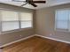 Bright bedroom with hardwood floors, neutral walls, ceiling fan and two bright windows at 105 Pandora Dr, Goose Creek, SC 29445