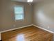 This bedroom features wood floors and a large window at 105 Pandora Dr, Goose Creek, SC 29445