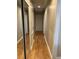 Hallway with hardwood floors, neutral walls, and closet space with mirror and storage at 105 Pandora Dr, Goose Creek, SC 29445