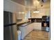 Bright kitchen featuring white cabinets, stainless steel appliances, and a new floor at 105 Pandora Dr, Goose Creek, SC 29445