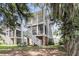 Charming backyard featuring a two-story porch and lush green lawn with shade trees at 1093 Ave Of Oaks, Charleston, SC 29407