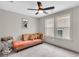 Bedroom with a couch, soft carpet, and bright windows overlooking the neighborhood at 1093 Ave Of Oaks, Charleston, SC 29407