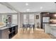 Stylish dining area with modern black table set, seamlessly integrated with the kitchen and living spaces at 1093 Ave Of Oaks, Charleston, SC 29407