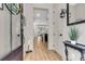 Welcoming entryway with light wood floors, elegant decor, and a view into the open living space at 1093 Ave Of Oaks, Charleston, SC 29407