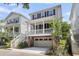 Inviting two-story home with a charming front porch, white railings, and a well-maintained garage at 1093 Ave Of Oaks, Charleston, SC 29407