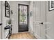 Stylish foyer with decorative mirror, lamps, and a view of the charming front door at 1093 Ave Of Oaks, Charleston, SC 29407