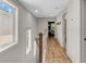 Upstairs hallway featuring hardwood floors and an open doorway at 1093 Ave Of Oaks, Charleston, SC 29407