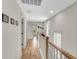 Upstairs hallway with hardwood floors and natural light at 1093 Ave Of Oaks, Charleston, SC 29407