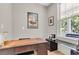Bright home office with large window, featuring a classic wooden desk and workspace at 1093 Ave Of Oaks, Charleston, SC 29407