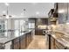 Gourmet kitchen with dark cabinetry, granite counters, stainless steel appliances, and open floor plan at 1093 Ave Of Oaks, Charleston, SC 29407