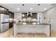 Bright kitchen features dark cabinets, marble countertops, stainless appliances, and modern lighting at 1093 Ave Of Oaks, Charleston, SC 29407