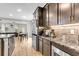 Spacious kitchen featuring granite countertops, stainless appliances, and a view into the dining area at 1093 Ave Of Oaks, Charleston, SC 29407