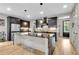 Modern kitchen with black cabinets, marble island, stainless appliances, and stylish pendant lighting at 1093 Ave Of Oaks, Charleston, SC 29407