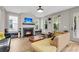 Welcoming living room with fireplace, hardwood floors, and stylish furniture under a modern ceiling fan at 1093 Ave Of Oaks, Charleston, SC 29407