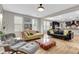 Open-concept living room with hardwood floors, comfortable seating, and seamless transition to the kitchen at 1093 Ave Of Oaks, Charleston, SC 29407