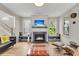 Cozy living room with fireplace, built-in benches, hardwood floors, and abundant natural light at 1093 Ave Of Oaks, Charleston, SC 29407
