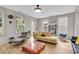 Inviting living room with hardwood floors, comfortable seating, and abundant natural light from large windows at 1093 Ave Of Oaks, Charleston, SC 29407
