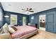 This main bedroom features hardwood floors, a ceiling fan, and access to a private balcony at 1093 Ave Of Oaks, Charleston, SC 29407