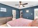 This main bedroom includes a ceiling fan, an ensuite bathroom, and a walk-in closet at 1093 Ave Of Oaks, Charleston, SC 29407