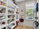 Spacious pantry with built-in shelving providing ample storage space and a bright window at 1093 Ave Of Oaks, Charleston, SC 29407
