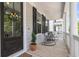 Inviting front porch featuring rocking chairs, columns, and a decorative floral wreath at 1093 Ave Of Oaks, Charleston, SC 29407