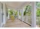 Outdoor porch showcasing a charming space with views of the surrounding trees at 1093 Ave Of Oaks, Charleston, SC 29407