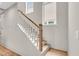 Bright staircase features hardwood steps, white risers and banisters, and a natural wood handrail at 1093 Ave Of Oaks, Charleston, SC 29407