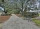 A scenic walking path lined with mature trees and a park bench offers a relaxing outdoor experience at 1093 Ave Of Oaks, Charleston, SC 29407