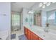 Bright primary bathroom with dual sinks, vanity, and bathtub with blue walls, and tile flooring at 111 Kapalua Run, Summerville, SC 29483