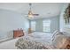Bright bedroom with a ceiling fan, complemented by neutral paint, a large bed and two windows at 111 Kapalua Run, Summerville, SC 29483