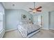 Bright bedroom with a ceiling fan, complemented by neutral paint, with a large bed and an en-suite bathroom at 111 Kapalua Run, Summerville, SC 29483