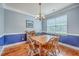 Dining room featuring hardwood floors, a classic chandelier, and a dining table with chairs at 111 Kapalua Run, Summerville, SC 29483