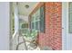 Cozy front porch featuring outdoor seating and brick accents at 111 Kapalua Run, Summerville, SC 29483
