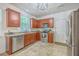 Well-lit kitchen features stainless steel appliances, granite countertops, and warm wood cabinets at 111 Kapalua Run, Summerville, SC 29483