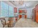 Bright kitchen with stainless steel appliances, tile floors, granite countertops, and wine barrel table at 111 Kapalua Run, Summerville, SC 29483