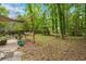 Expansive backyard featuring a custom playset, lush trees and an outdoor living space at 116 Runnymede Ln, Summerville, SC 29485