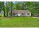 Charming single-story home with a well-manicured lawn, surrounded by lush trees at 116 Runnymede Ln, Summerville, SC 29485