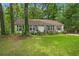 A beautiful, single-story home featuring a lush green lawn and mature trees in a serene setting at 116 Runnymede Ln, Summerville, SC 29485