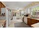 Kitchen with wood cabinetry, white appliances, ample counter space and window views at 116 Runnymede Ln, Summerville, SC 29485