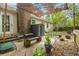 Relaxing outdoor patio area with shade, brick chimney, and comfortable seating at 116 Runnymede Ln, Summerville, SC 29485