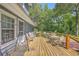 Spacious back deck featuring multiple seating areas and a view of the wooded backyard at 121 Woodland Dr, Summerville, SC 29485