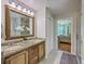 Bathroom featuring a double sink vanity with granite counters and a large framed mirror at 121 Woodland Dr, Summerville, SC 29485