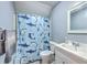 Bathroom with blue walls featuring a vanity with framed mirror and shower with decorative shower curtain at 121 Woodland Dr, Summerville, SC 29485