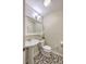 Clean half bathroom featuring pedestal sink, toilet, and decorative tile flooring at 121 Woodland Dr, Summerville, SC 29485
